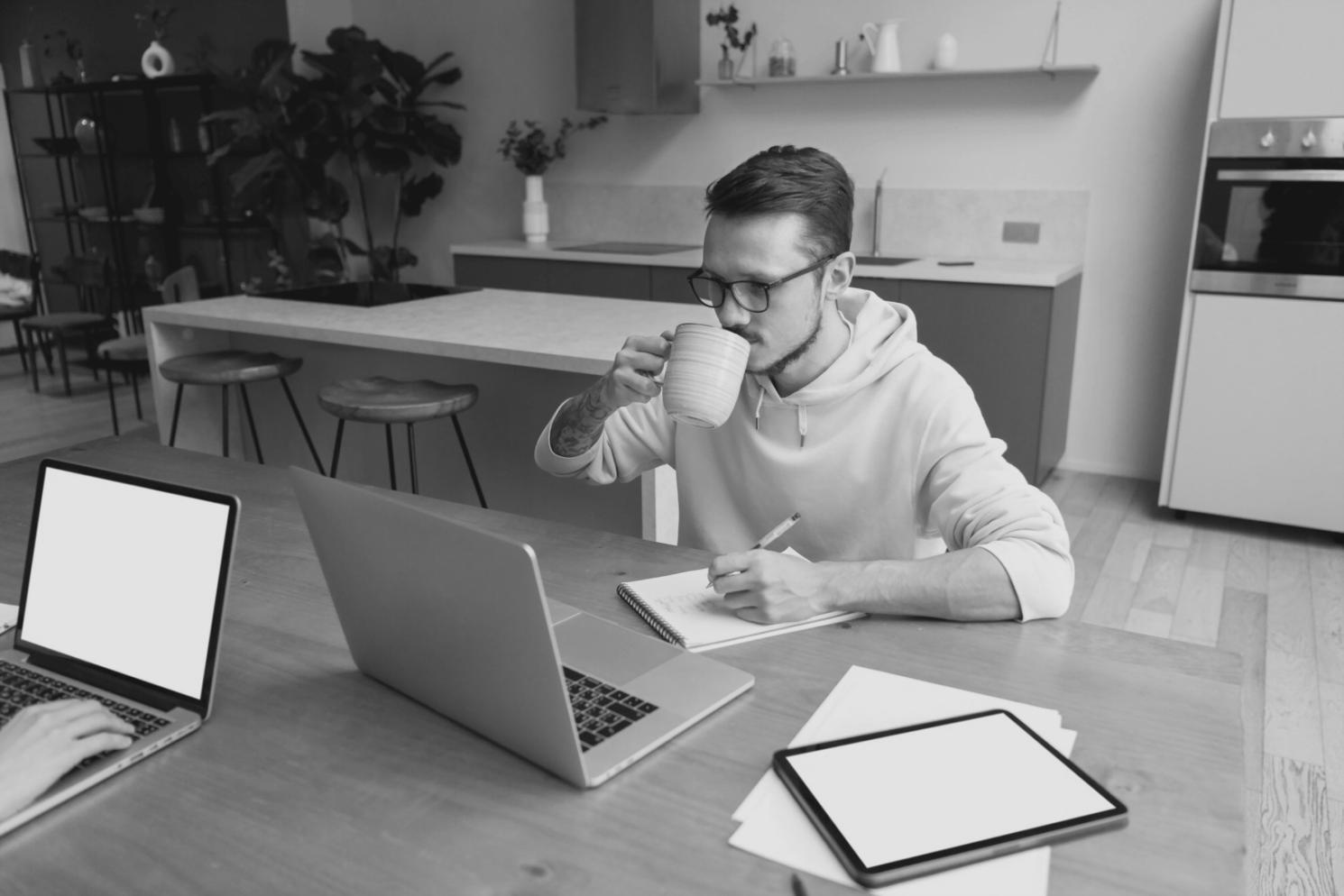 Students working on investment application interfaces with multiple monitors displaying financial dashboards and code